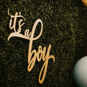 it's a boy sign on greenery